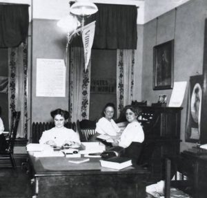 State campaign Headquarters for 1912 Suffrage Campaign, Eva McCall Hamilton at center table, Grand Rapids History and Special Collections (GRHSC), Archives, GRPL, GR, Michigan.